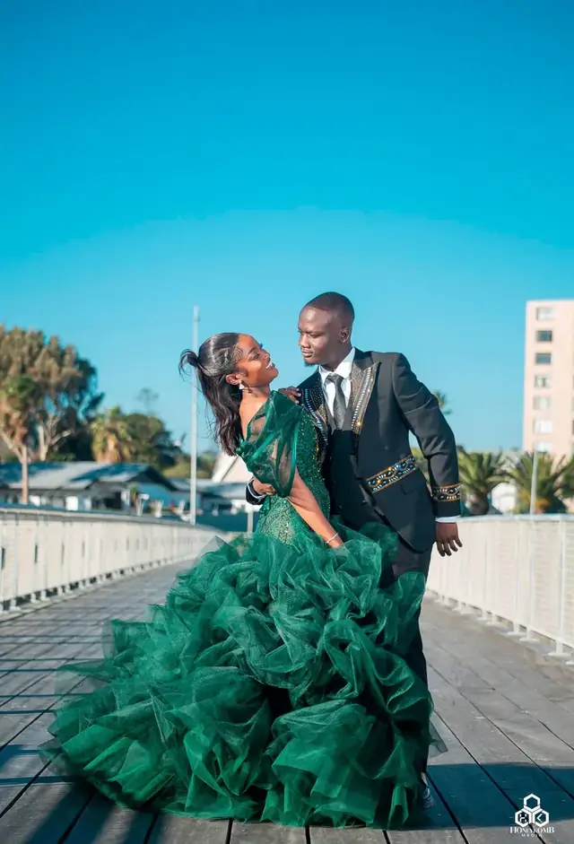 Wedding couple on the pier in a green gown