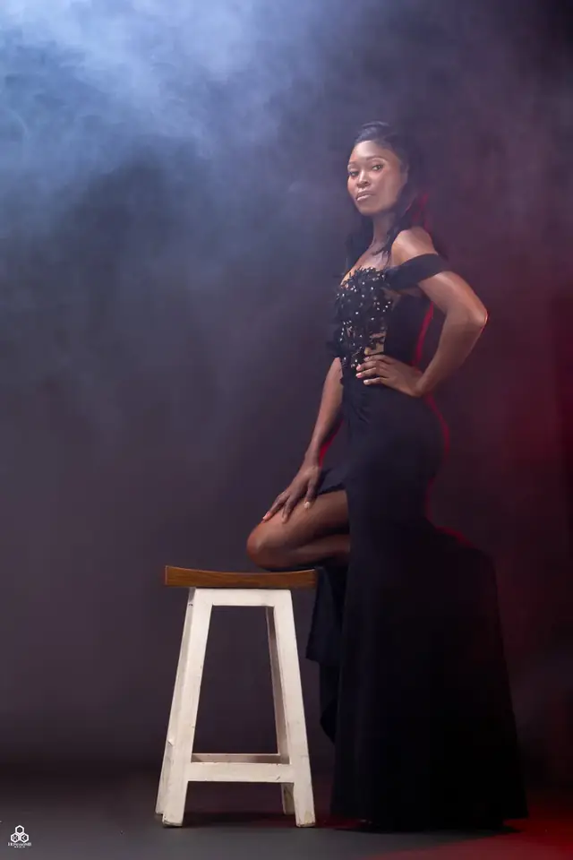 Studio portrait in a black dress with stage smoke