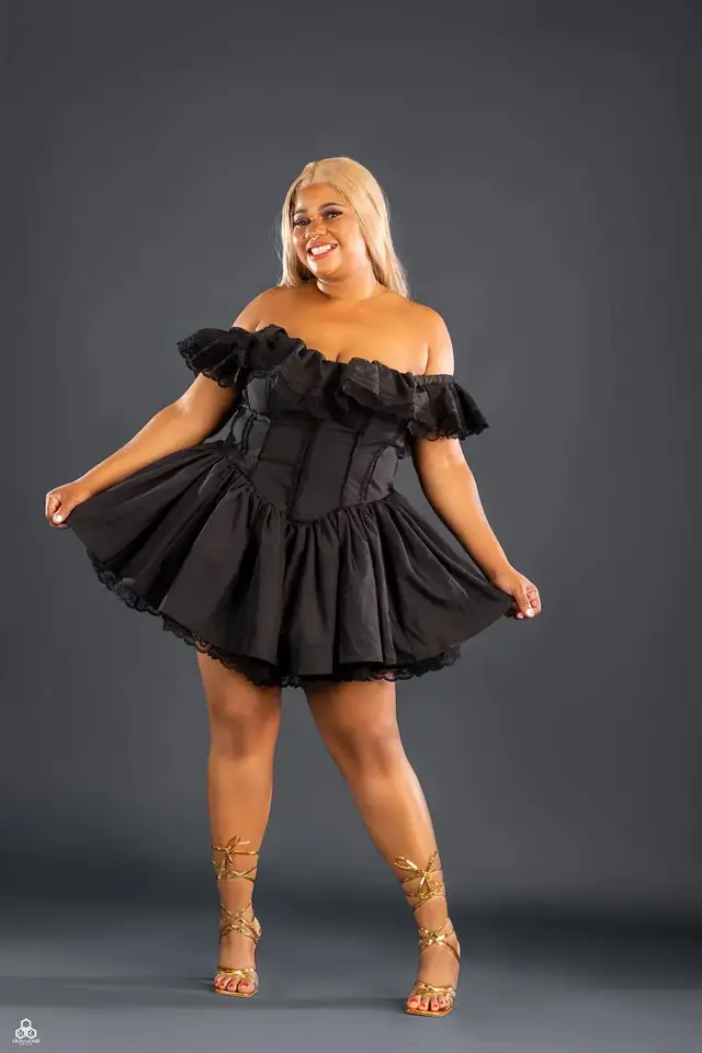 Studio portrait in a black ruffle dress
